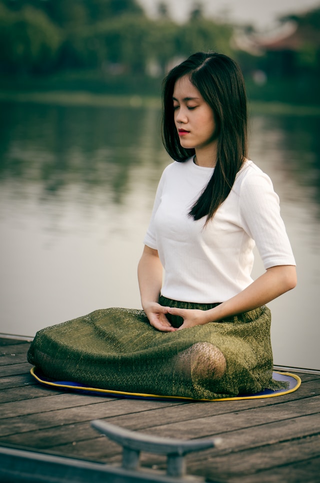 person meditating in cross legged position