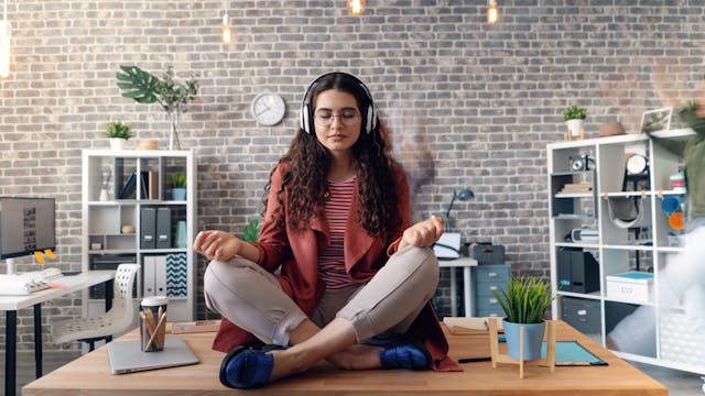 Student meditating at desk